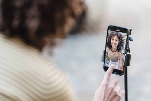 smiling blogger recording a video of herself